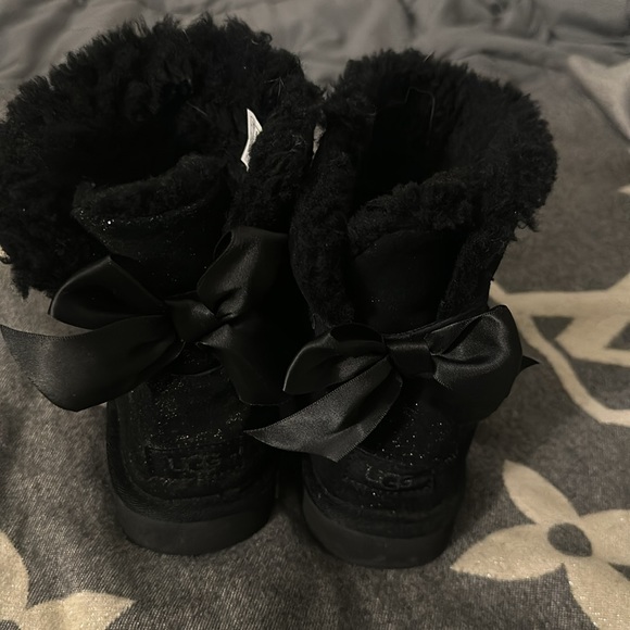 UGGs for sale. Women’s size 7. They are black with gold and a bow on the back. - Picture 2 of 6